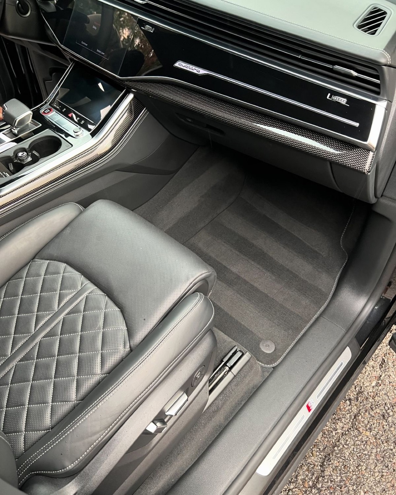 A car raised on the ramp inside the Platinum Urban Gloss Mobile Detailing London workshop bay